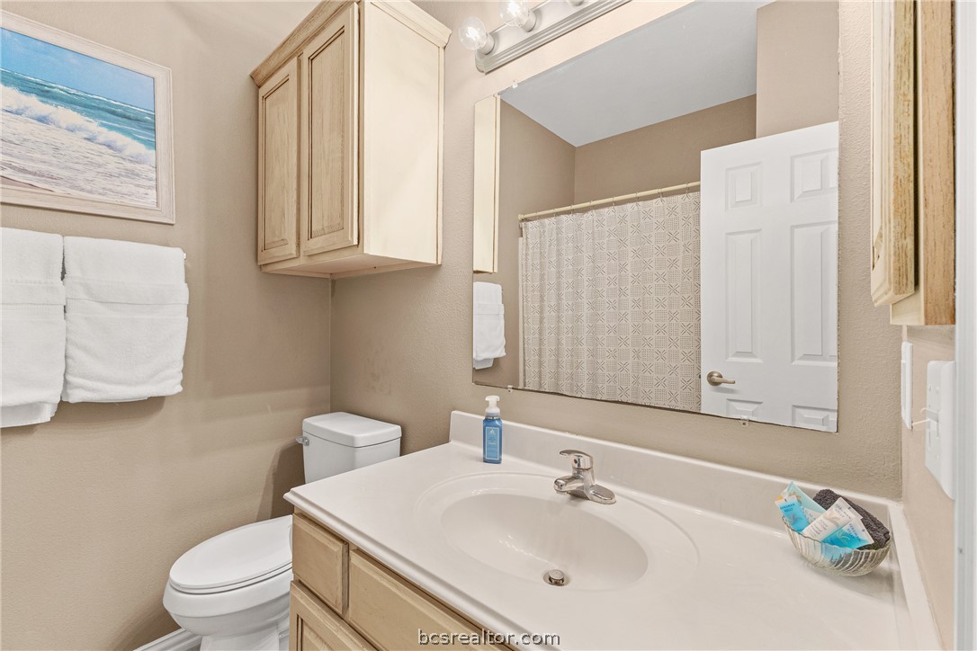1001 Krenek Tap Road, Unit 1306 College Station, TX 77840 - Photo 11 of 22 a bathroom with a sink a toilet and a mirror