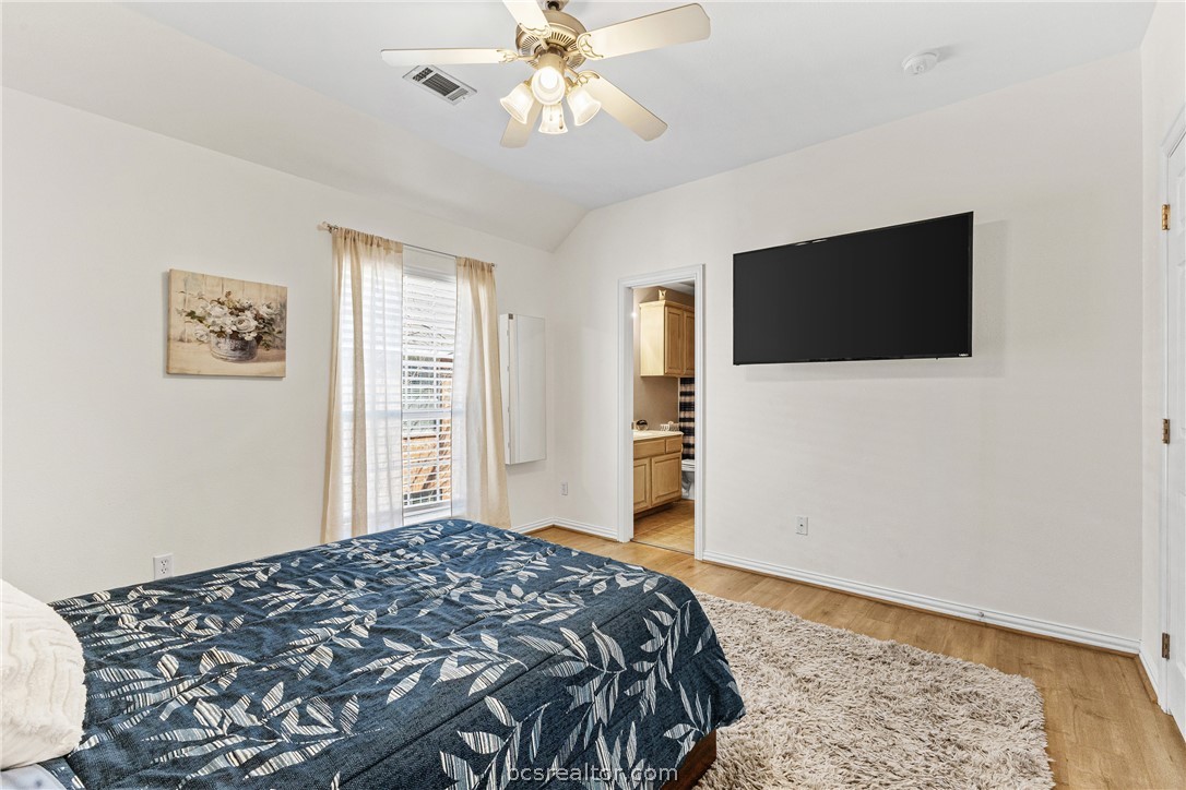 1001 Krenek Tap Road, Unit 1306 College Station, TX 77840 - Photo 12 of 22 a bedroom with a bed and a flat screen tv
