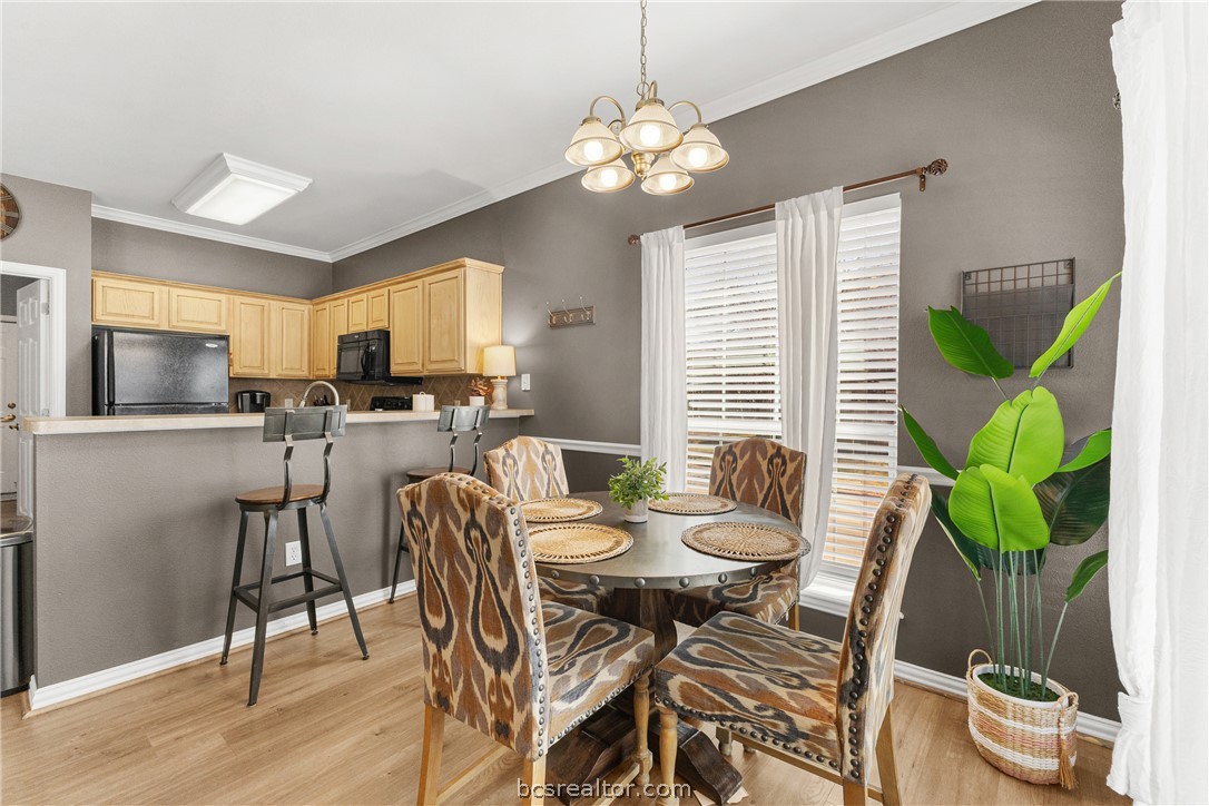 1001 Krenek Tap Road, Unit 1306 College Station, TX 77840 - Photo 3 of 22 a dining room with furniture potted plants and wooden floor