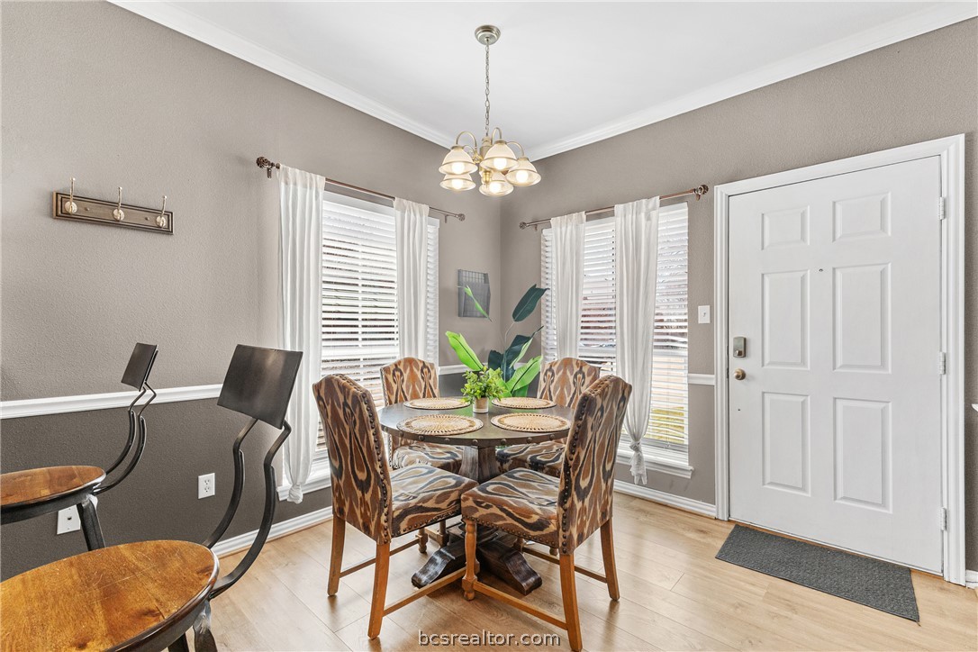 1001 Krenek Tap Road, Unit 1306 College Station, TX 77840 - Photo 6 of 22 a dining room with furniture a chandelier and wooden floor