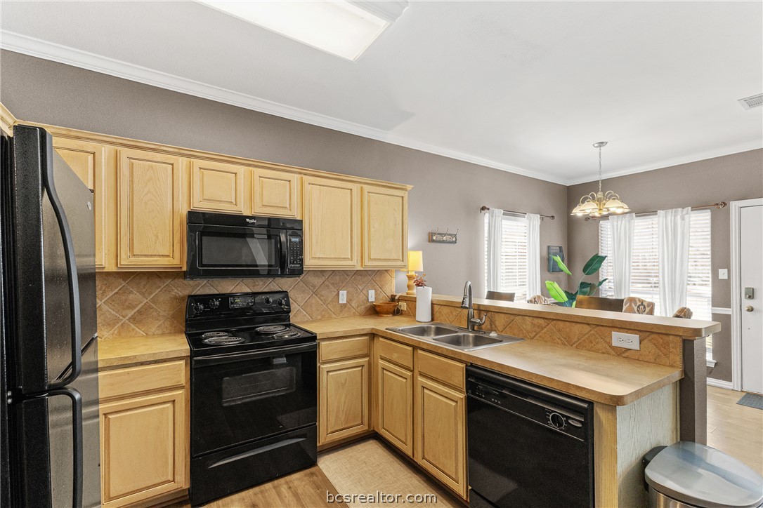 1001 Krenek Tap Road, Unit 1306 College Station, TX 77840 - Photo 7 of 22 a kitchen with a sink stove top oven and refrigerator