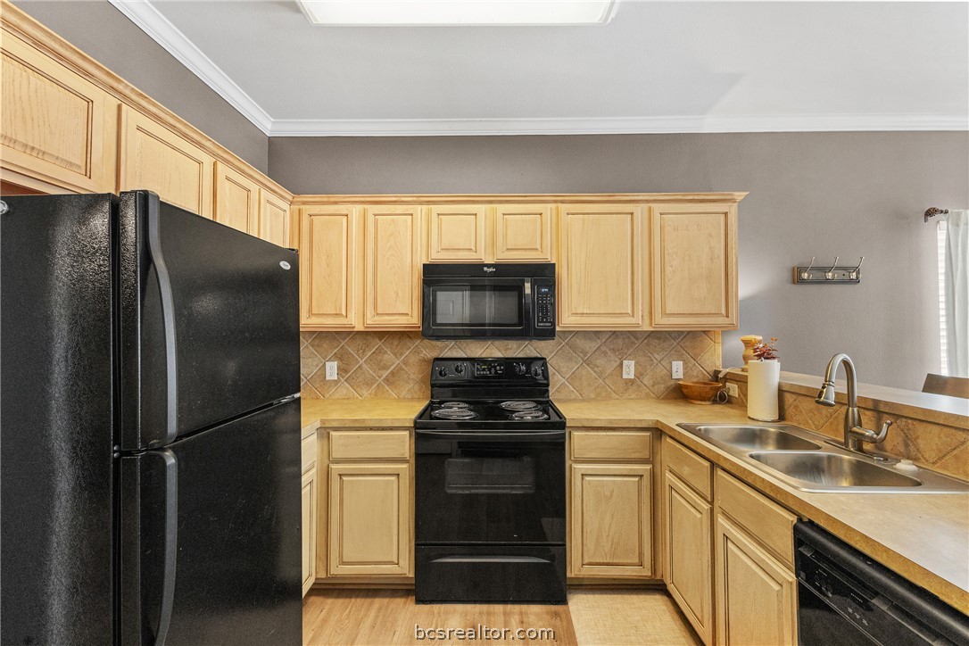 1001 Krenek Tap Road, Unit 1306 College Station, TX 77840 - Photo 8 of 22 a kitchen with a refrigerator stove and sink