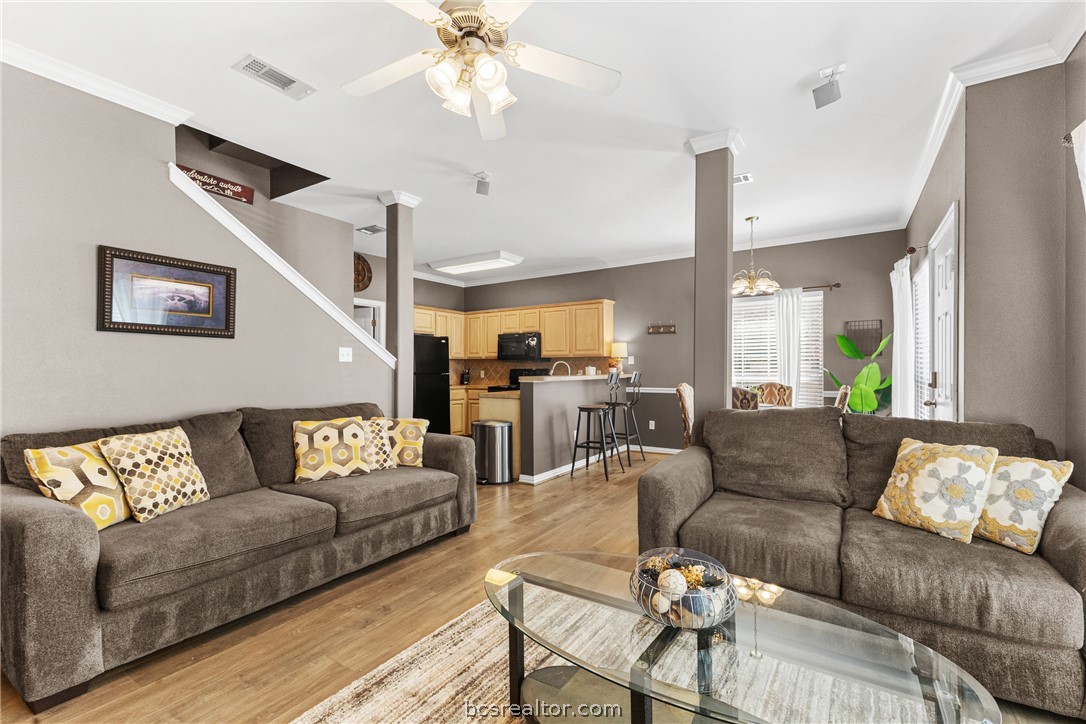 1001 Krenek Tap Road, Unit 1306 College Station, TX 77840 - Photo 9 of 22 a living room with furniture and a chandelier