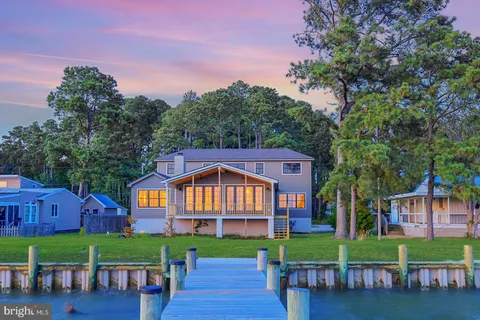 a very nice looking room with a large window and wooden floor