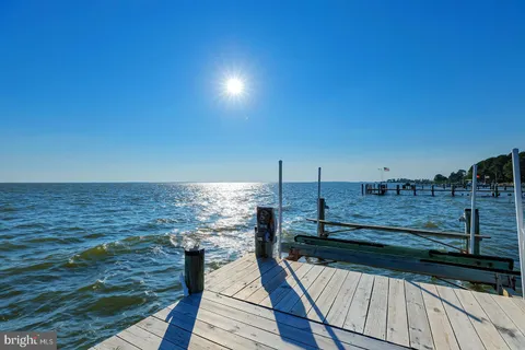 a bathroom with a granite countertop toilet sink and mirror