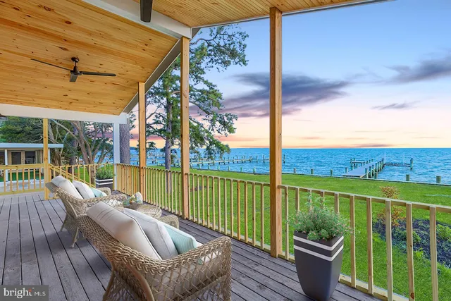 a view of empty room with wooden floor and fireplace