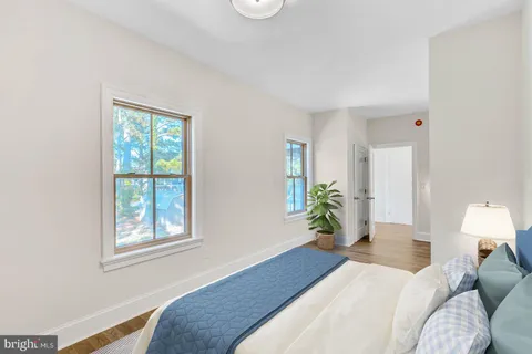 an aerial view of residential houses with outdoor space and parked