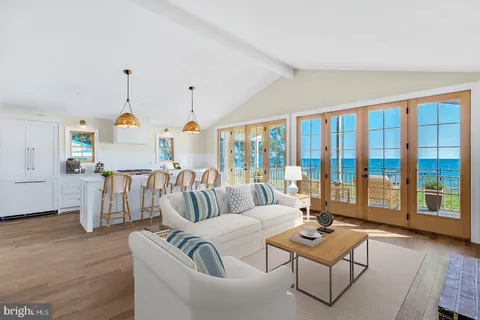 a kitchen with stainless steel appliances granite countertop a stove a sink dishwasher and a wooden floor