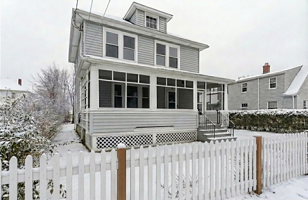 a front view of a house with a fence