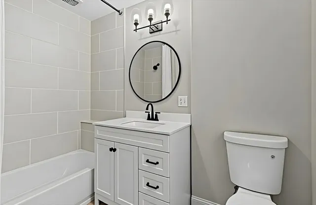 a bathroom with a sink a toilet and a mirror