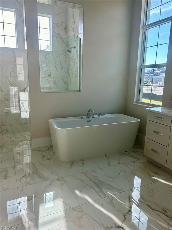 8835 Nevis Way Naples, FL 34112 - Photo 2 of 5 a white bath tub sitting next to a white sink