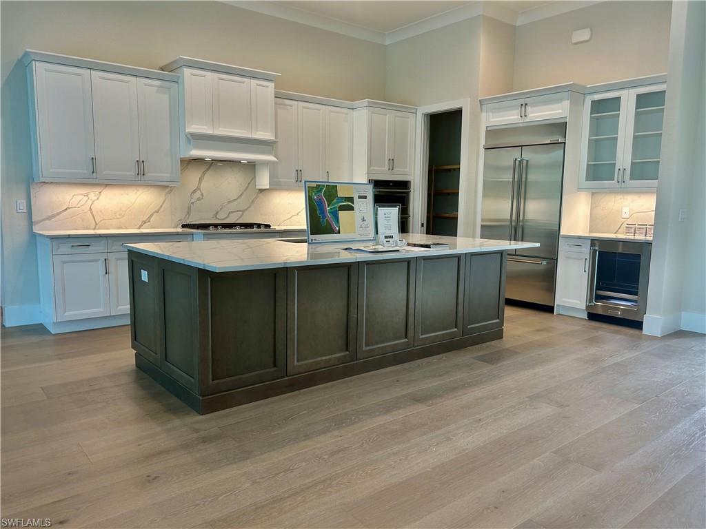 8835 Nevis Way Naples, FL 34112 - Photo 5 of 5 a kitchen with stainless steel appliances granite countertop a sink and a stove