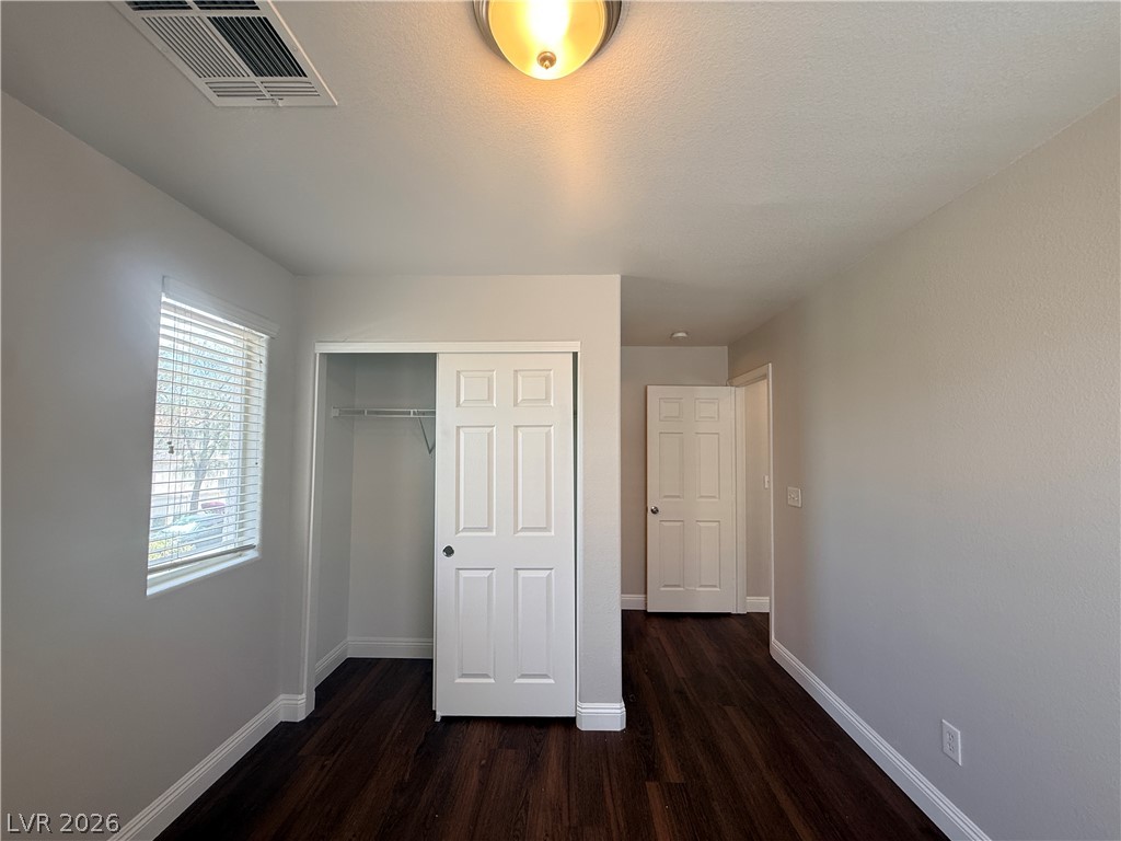 11953 Fairfax Ridge Street Las Vegas, NV 89183 - Photo 22 of 32 Rich hardwood-style flooring extends through this naturally lit, inviting room, featuring a convenient sliding closet.