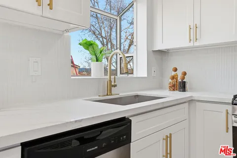 a kitchen with a sink and a window