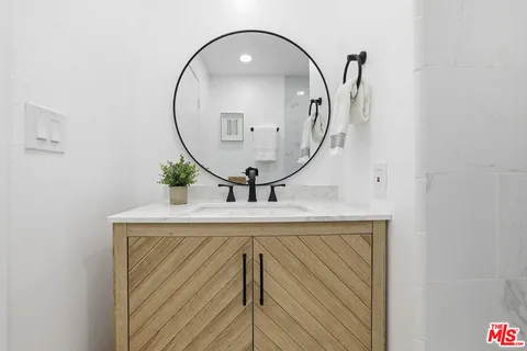 a bathroom with a sink mirror and vanity