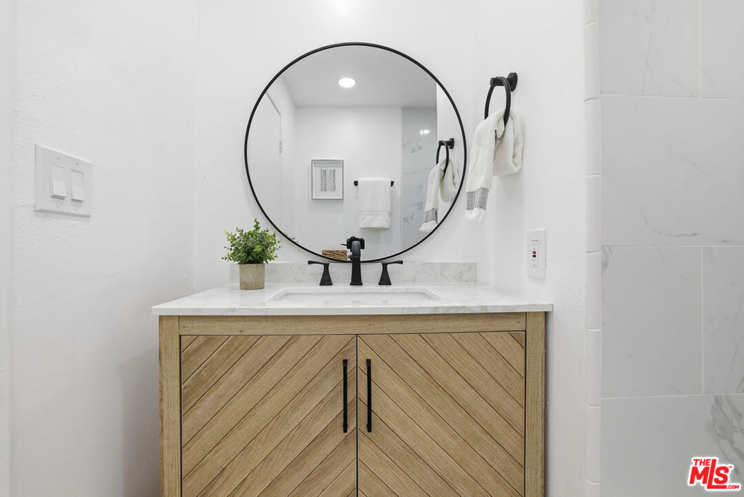 19834 Sandpiper Place, Unit 64 Newhall, CA 91321 - Photo 17 of 40 a bathroom with a sink mirror and vanity
