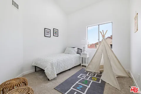 a bedroom with a bed and a couch