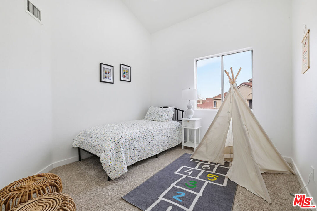 19834 Sandpiper Place, Unit 64 Newhall, CA 91321 - Photo 20 of 40 a bedroom with a bed and a couch