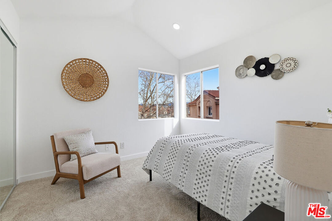 19834 Sandpiper Place, Unit 64 Newhall, CA 91321 - Photo 23 of 40 a bedroom with a bed and painting on the wall