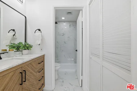 a bathroom with a shower and a sink