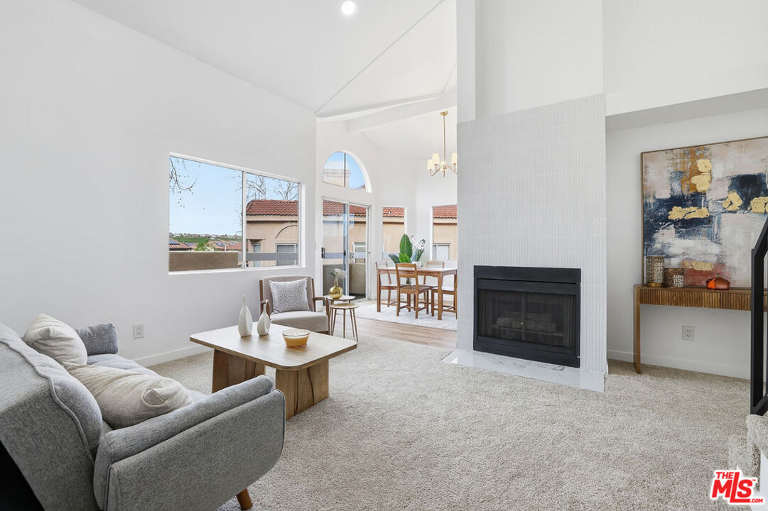 19834 Sandpiper Place, Unit 64 Newhall, CA 91321 - Photo 3 of 40 a living room with furniture and a fireplace
