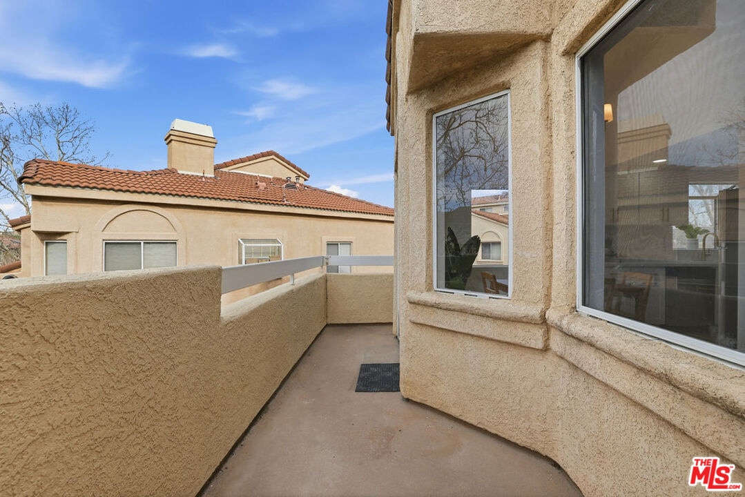 19834 Sandpiper Place, Unit 64 Newhall, CA 91321 - Photo 33 of 40 a view of a white house with windows