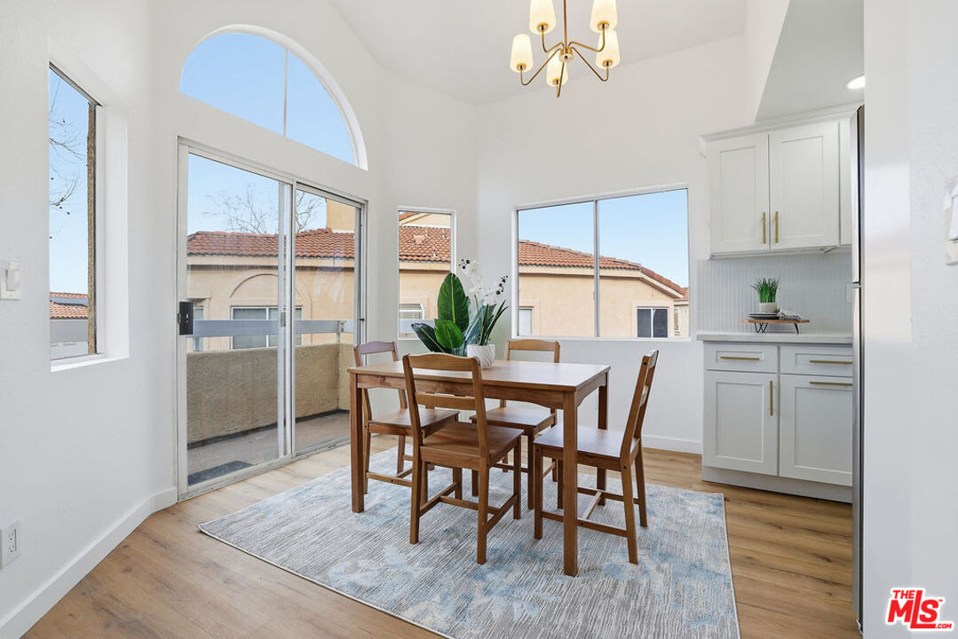 19834 Sandpiper Place, Unit 64 Newhall, CA 91321 - Photo 10 of 40 a view of a dining room with furniture window and wooden floor