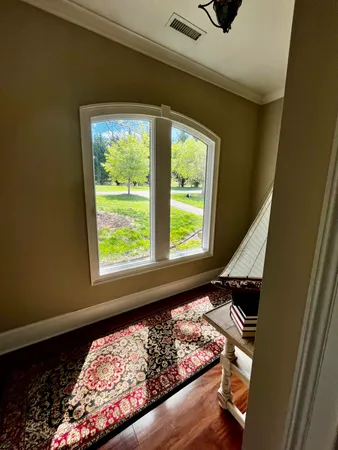 a bed sitting in a bedroom next to a window