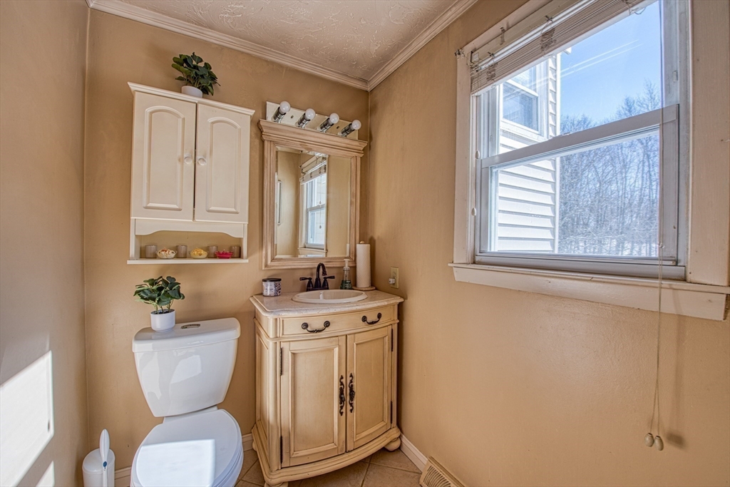 12 Brewster Road Randolph, MA 02368 - Photo 17 of 27 a bathroom with a toilet a sink and a mirror