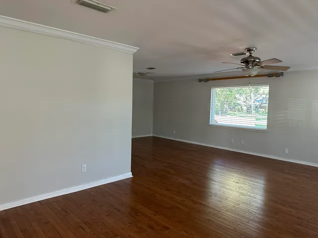 a view of an empty room with a fireplace and a window