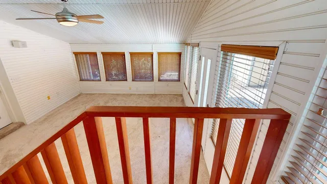 a view of a room with wooden floor and entryway