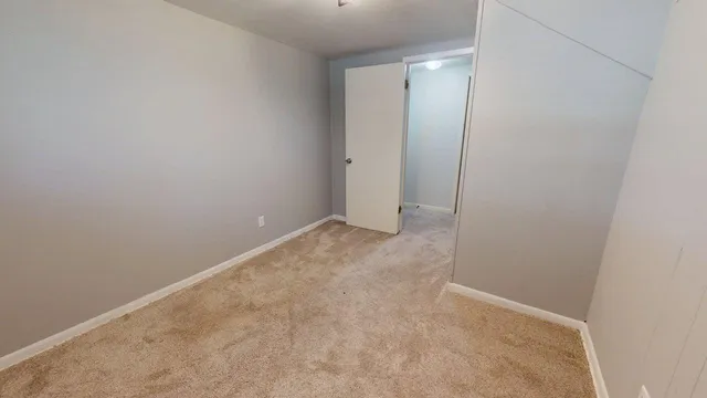 a view of a livingroom with a staircase and a ceiling fan