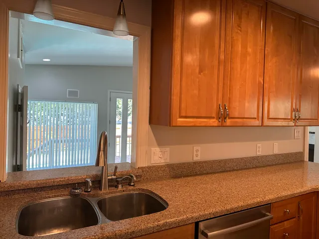 a white toilet sitting next to a bathroom sink and vanity
