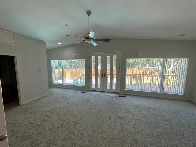 a balcony with wooden floor and outdoor seating