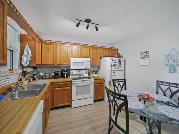 a kitchen with a sink appliances and cabinets