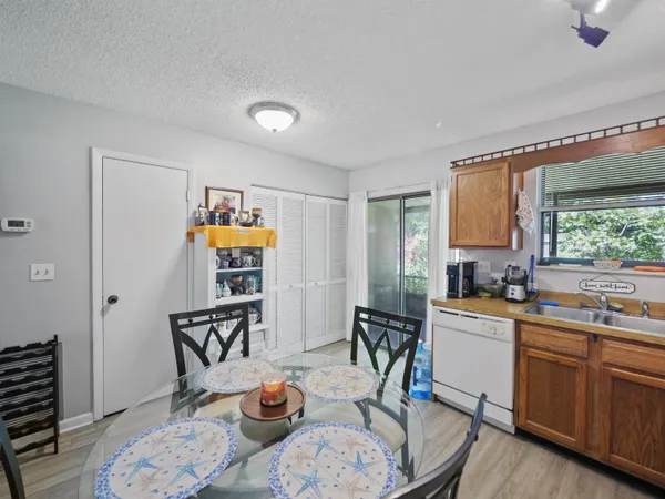 a kitchen that has a table and chairs in it