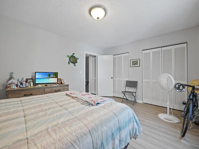 a bedroom with a bed and a chair