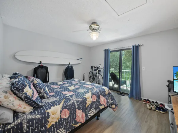 a bedroom with a bed and a large window with outer view