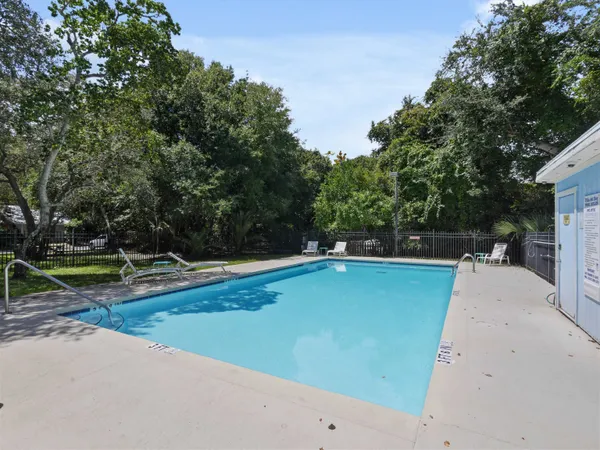 a view of a swimming pool with a yard