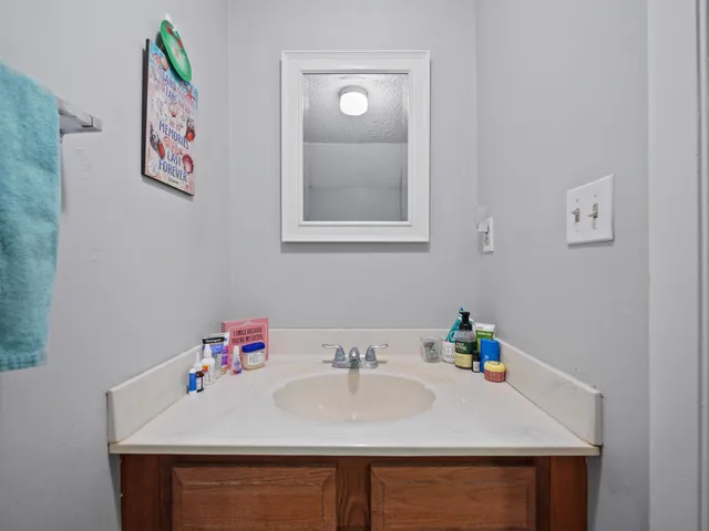 a bathroom with a sink a vanity and a mirror