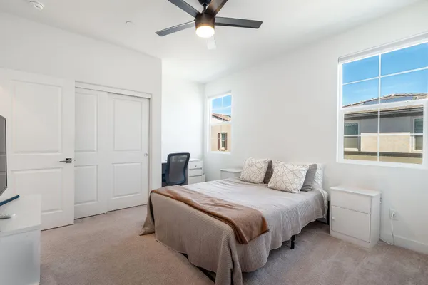 a bedroom with a bed and a flat screen tv