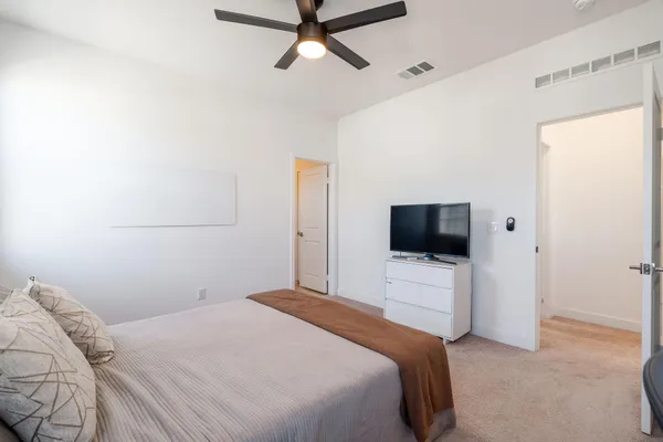 a bedroom with a bed and a window