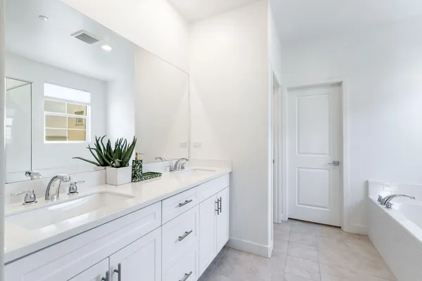 a bathroom with a tub a sink and a shower