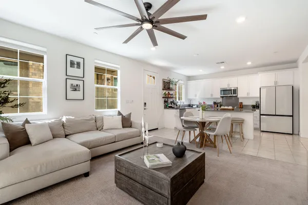 a living room with furniture kitchen and a window