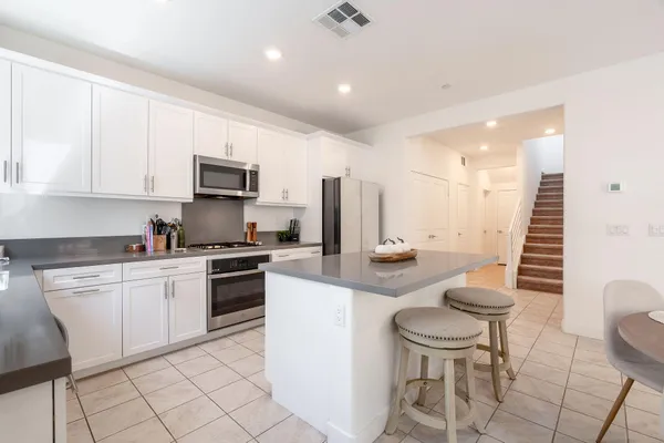a kitchen with a sink a stove cabinets and a counter top space