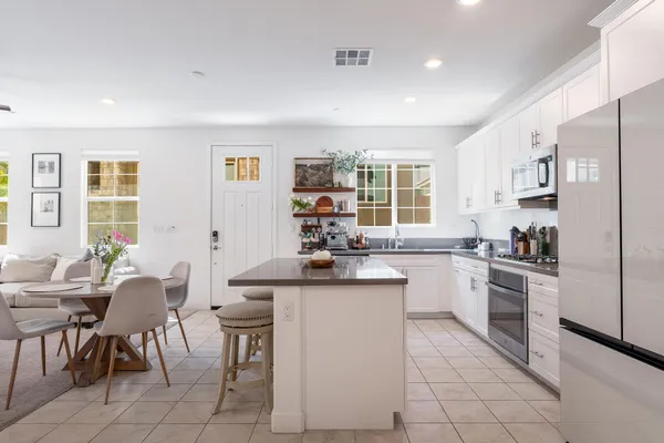 a kitchen with stainless steel appliances kitchen island granite countertop a sink and cabinets