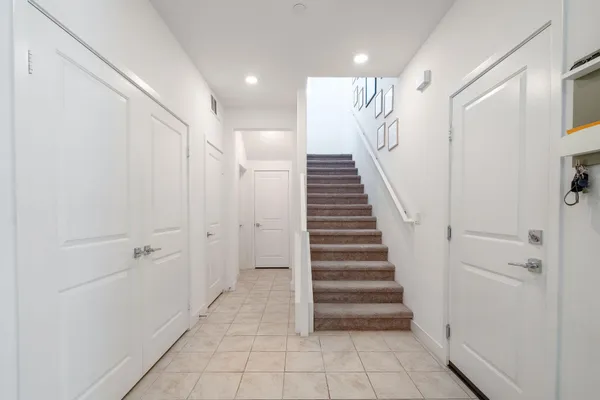 a view of entryway with stairs and white walls