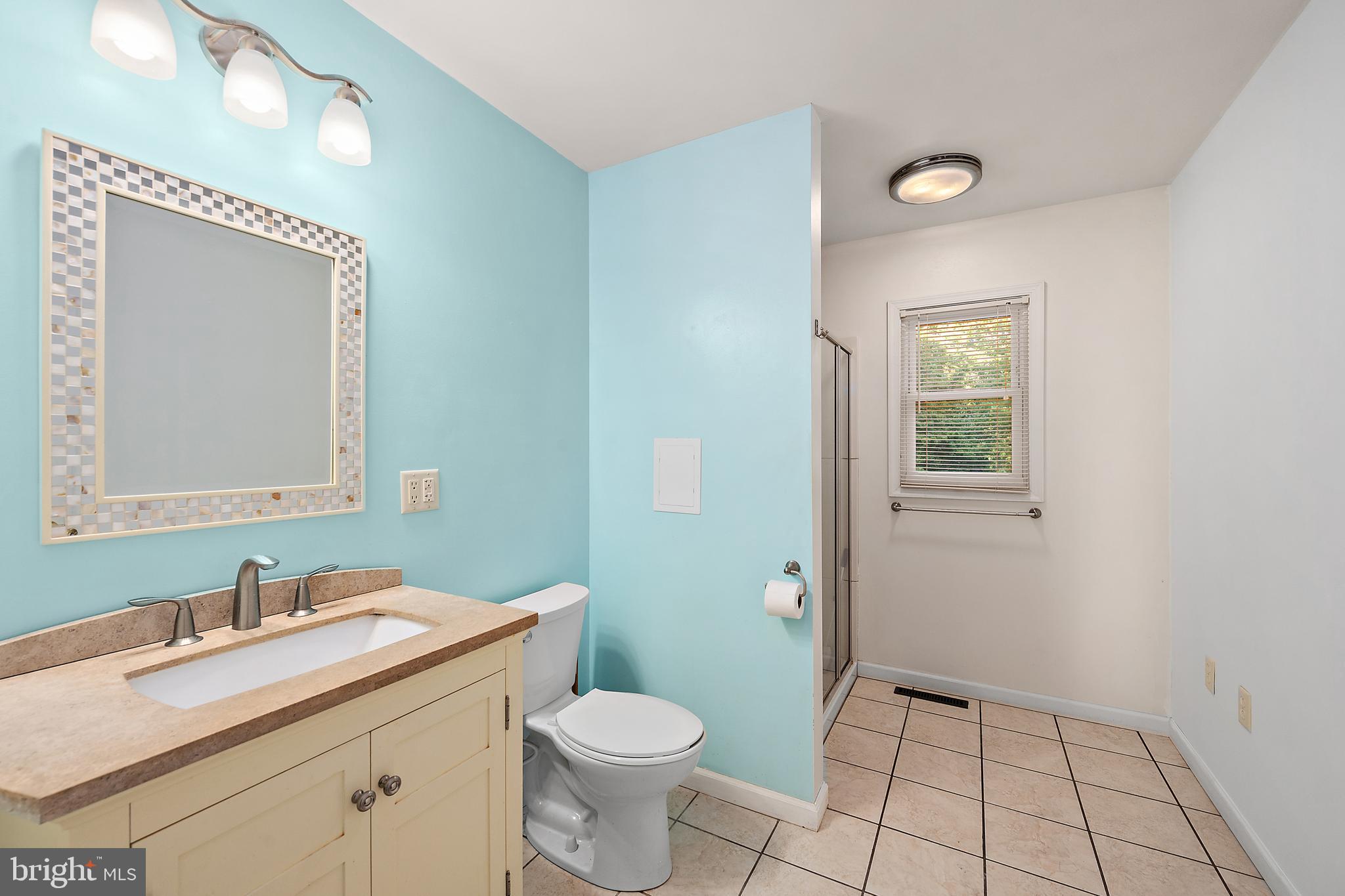 6181 Rockawalkin Road Salisbury, MD 21801 - Photo 24 of 65 a bathroom with a granite countertop sink toilet and mirror