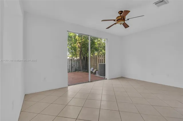 a view of a livingroom with a ceiling fan and window