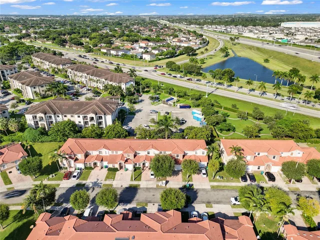 an aerial view of residential houses with outdoor space